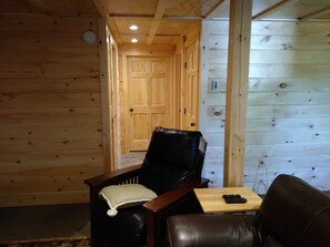 Hallway to the bathroom, King bed, and utility room (lower lever/ground floor).