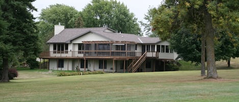 Wrap-around deck with screened patio overlooking back yard and golf course.