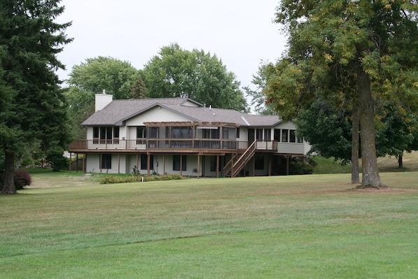 Wrap-around deck with screened patio overlooking back yard and golf course.