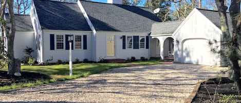 View of front of house with crushed shell driveway.