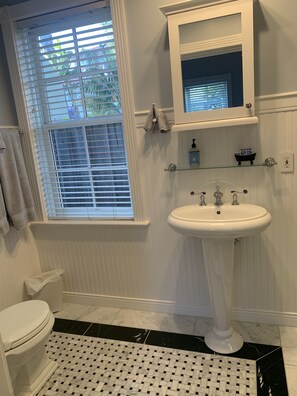 Bathroom with all natural stone, pedestal sink, medicine cabinet