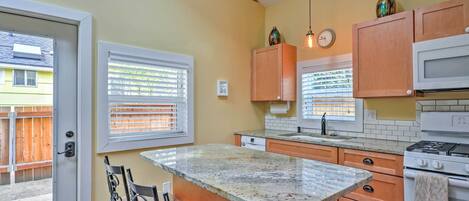 Well stocked kitchen with tile and granite countertops