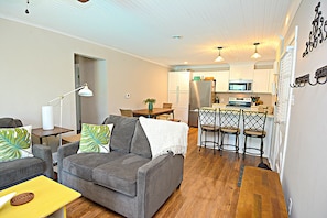 Bungalow living room with view of kitchen.