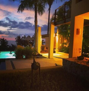 Lower Balcony, pool and beach view at night.