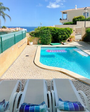 pool deck with loungers, and towels