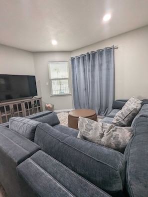 Spacious new sofa, TV in each room.