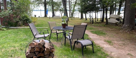 Table or picnic table, bundle of firewood, Solo Stove fire pit