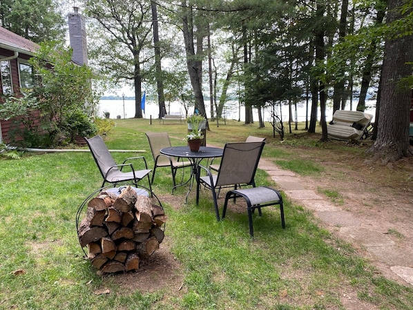 Table or picnic table, bundle of firewood, Solo Stove fire pit