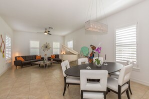 Open floor plan living room with baby grand piano and formal dinning area.