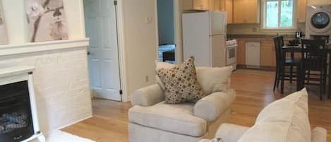 Open concept floor plan. Living room with fireplace that leads into the kitchen.