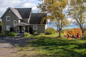 an exterior fire place nearby with a view on the river
