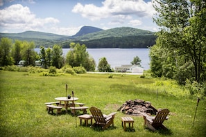 View from the deck - see the field stone fireplace of the lake & mountains