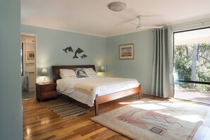 Relax in the primary bedroom with a king bed, direct deck access and a walk-in wardrobe to keep your stay clutter-free.