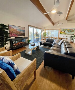 Large casual living area with Smart Samsung TV, fireplace and reclining lounge