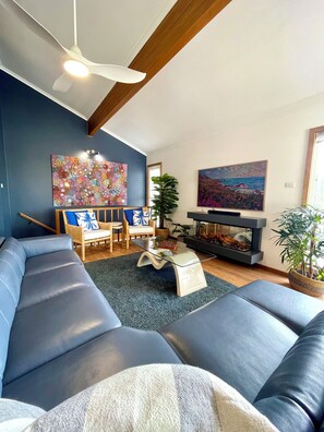 Large casual living area with Smart Samsung TV, fireplace and reclining lounge