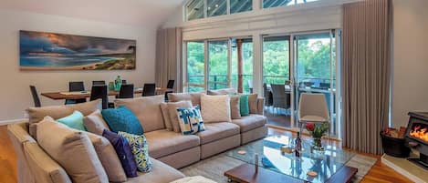 Sink into the expansive L-shaped sofa in the open-plan living area, watch your favourite TV shows or unwind by the wood-burning fireplace with a glass of local wine.