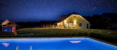 night view of the house from the swimming pool