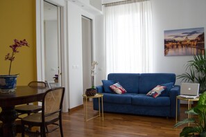 LivingRoom double sofabed, round table, 2hight sliding doors lead to  kitchen