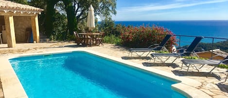 Swimming pool level with bbq and sea views