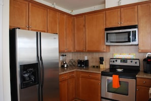 Full size kitchen with all appliances, utensils and dishes.