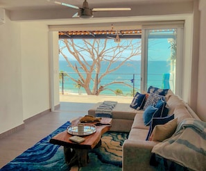 Spacious living room with comfortable seating and ocean views.