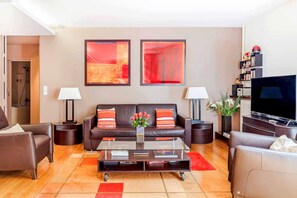 Gorgeous warm colour scheme. Italian leather couch and reclining chairs.
