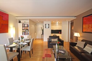 Large modern living and dining area. Kitchen in the back right side