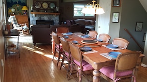 Dining room with oversize Maple Wood table seats up to 12 people.