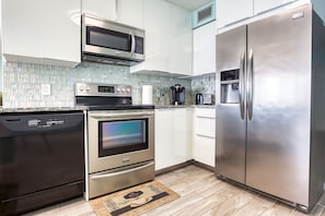 Stainless steel appliances and granite countertops.