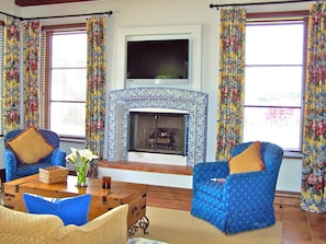 easy-to-use gas fireplace in living area with view to rose garden.