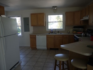 large spacious kitchen
with utensils, pans, etc.