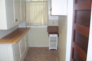 The Butler Pantry in the kitchen stores pots, pans, coffee & other cooking items