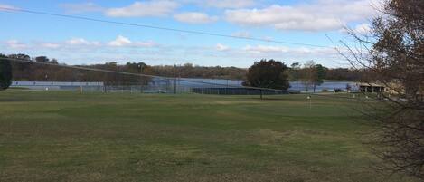 view of golf course and lake at country club