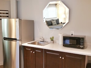 Kitchenette includes microwave, toaster coffeemaker, electric kettle & dishes. 