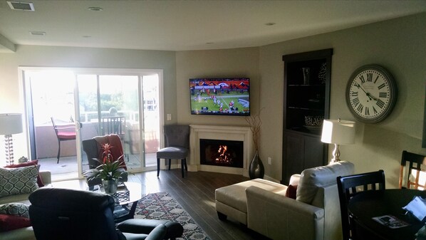 living room with gas fireplace and 55' LCD television, ocean view from balcony