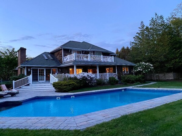 Expansive back yard with large deck, heated pool, putting green, chipping areas.