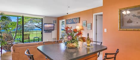 Open concept sitting at dining table overlooking living room and view