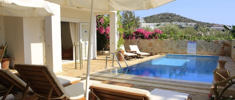 A tranquil morning, sun, blue skies and an inviting pool.