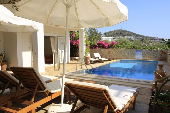 A tranquil morning, sun, blue skies and an inviting pool.