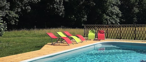 Deck chairs around swimming pool