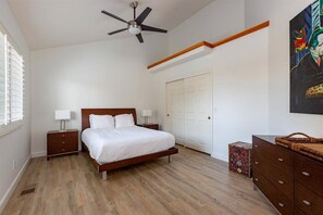 Bedroom featuring queen bed, closet, and dresser