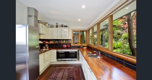 Full kitchen with double miele oven, gas cooktop, miele fridge