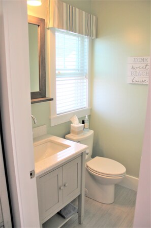 Full bath off entry. Stall shower is behind door.