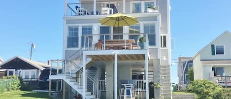 High tide. Small lawn area. Grill, bar/lounge under house. 3 of 4 decks shown.