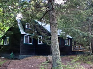 Cottage side that faces the lake, beah, and mountain.