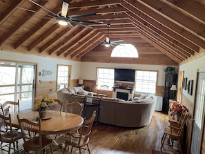 Great room with plenty of windows to the trees outside and views of the mountain