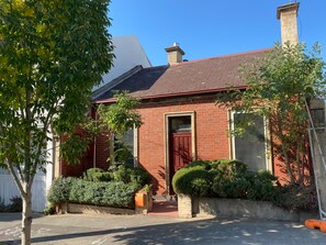 The streetscape, with rosemary bushes. 2021