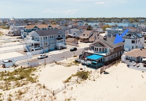 Large yard with beach sand. House also has multiple ocean facing decks.