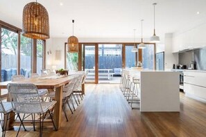 Large kitchen and dining area opening to outdoor deck