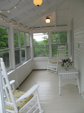 Wrap around Screened in Porch with Rocking Chairs